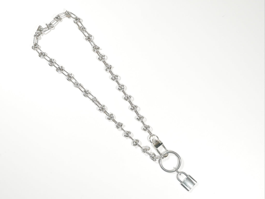 Silver chain with a lock on a white background