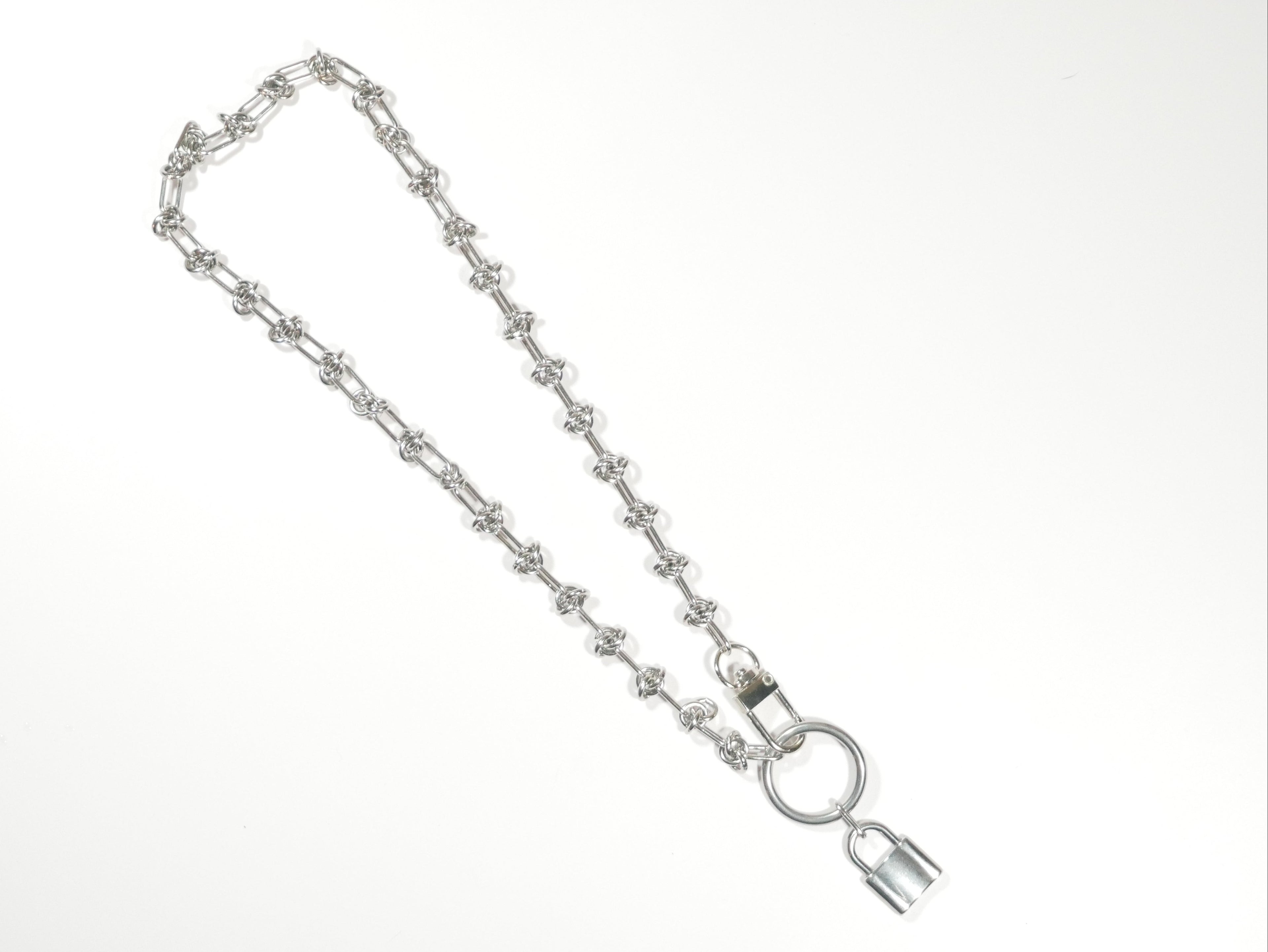 Silver chain with a lock on a white background