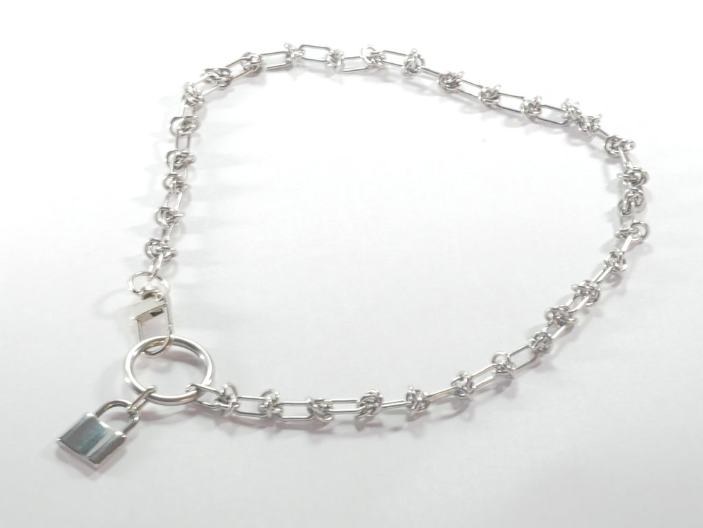 Silver bracelet with a lock charm on a white background