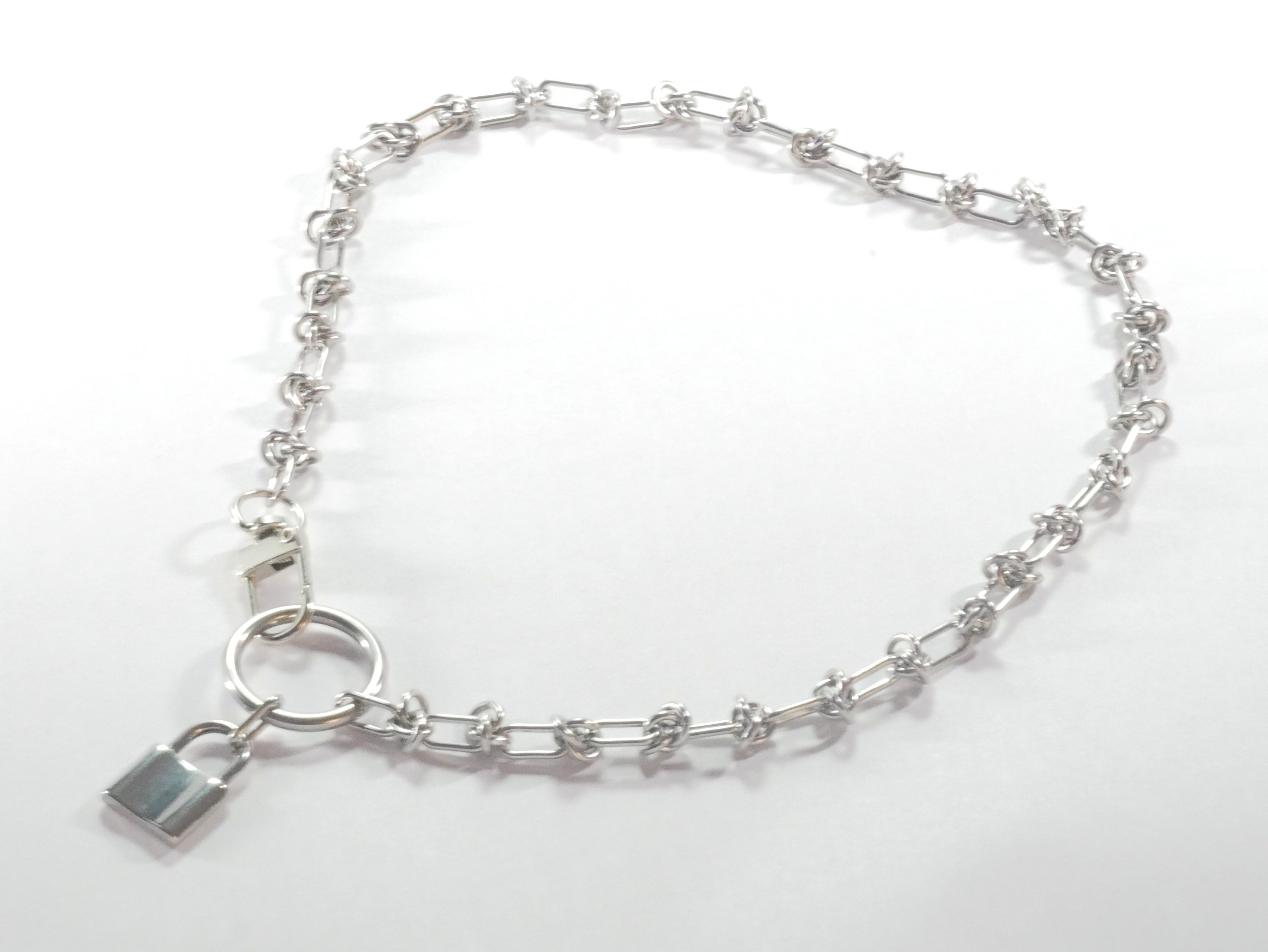 Silver bracelet with a lock charm on a white background