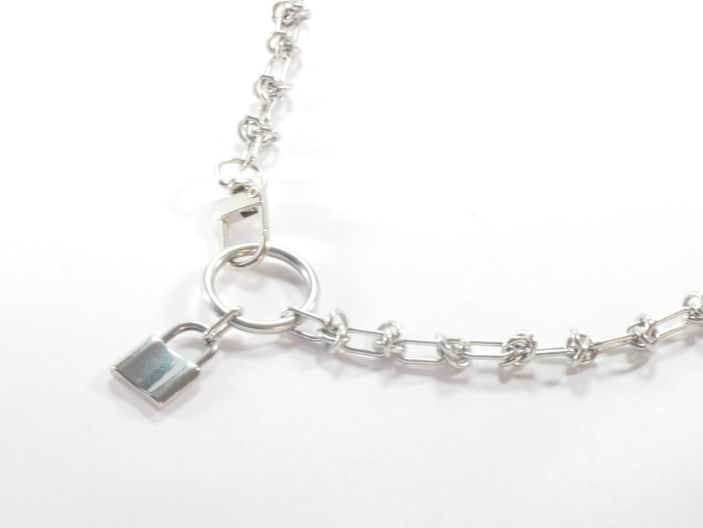 Silver chain bracelet with a lock charm on a white background