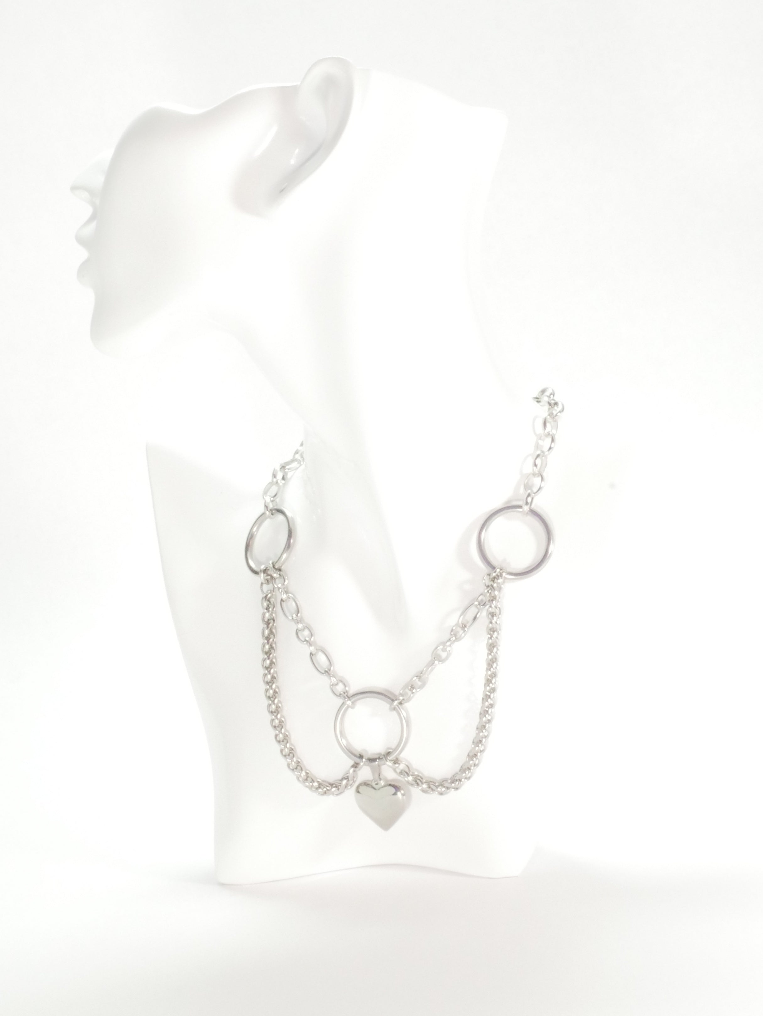 Silver chain necklace on a mannequin with a white background