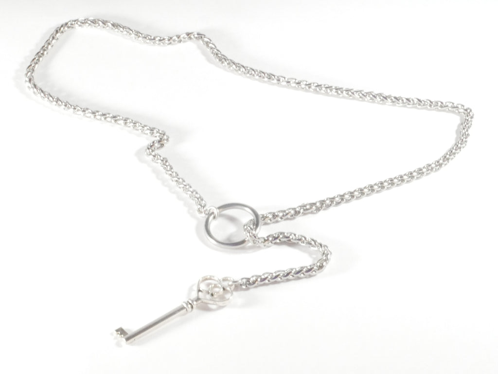 Silver key necklace on a white background