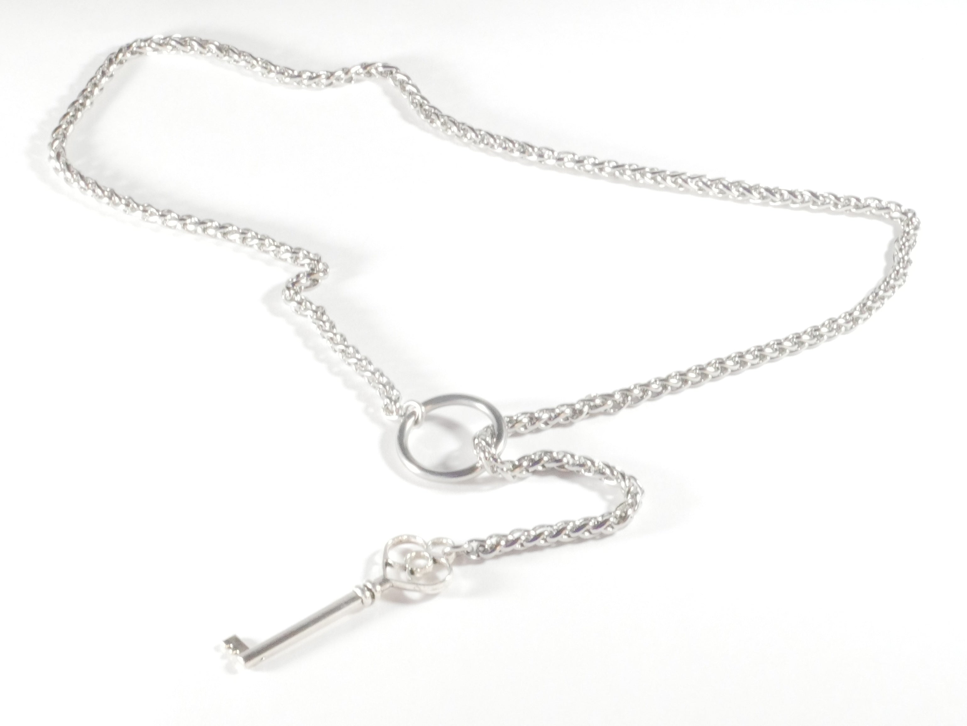 Silver key necklace on a white background