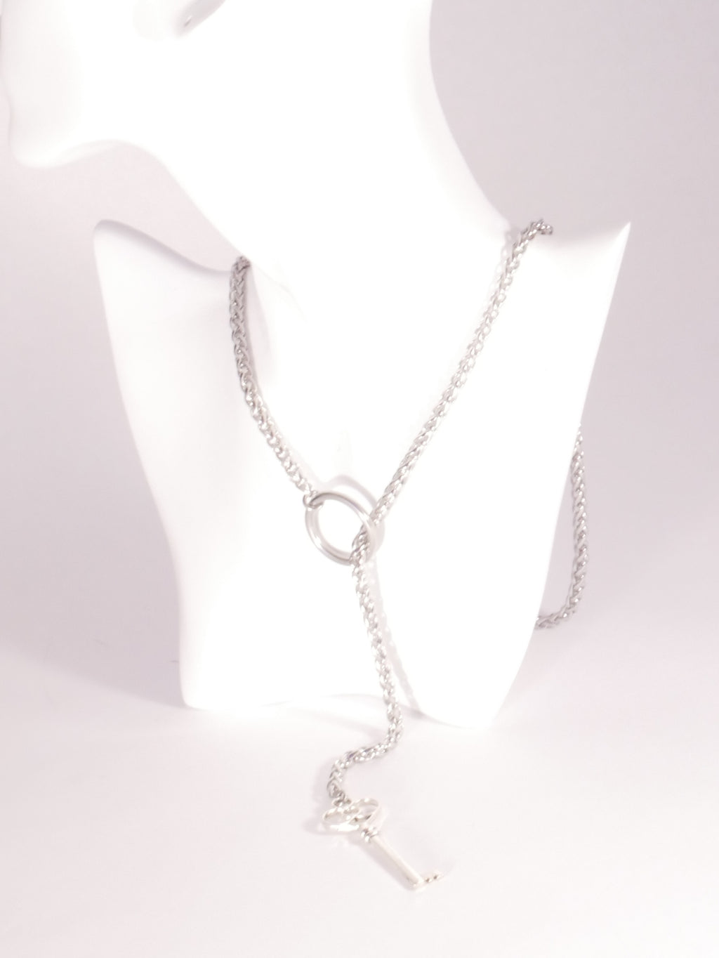 Silver necklace on a mannequin with a white background