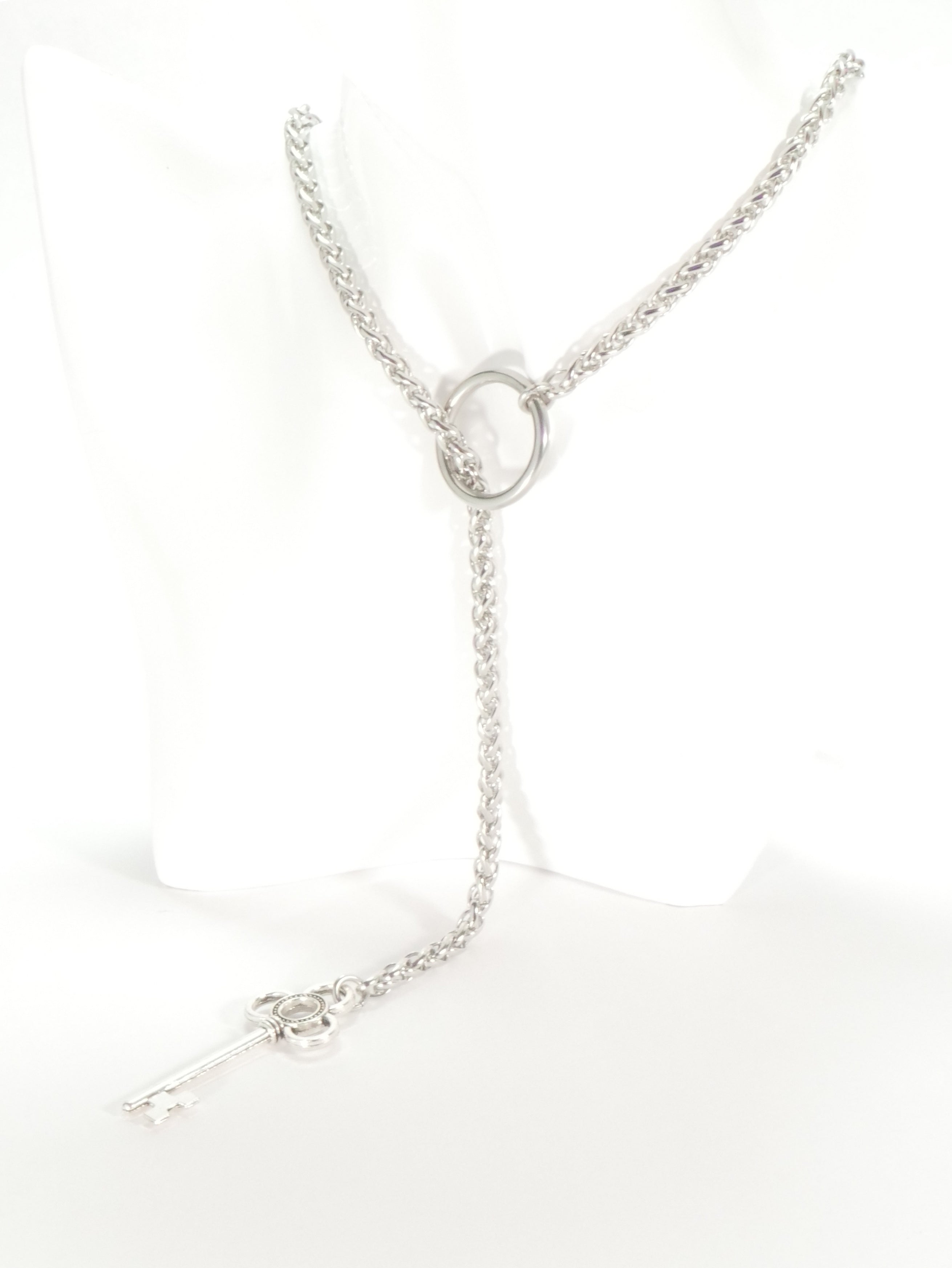 Silver necklace with a circular pendant on a white background