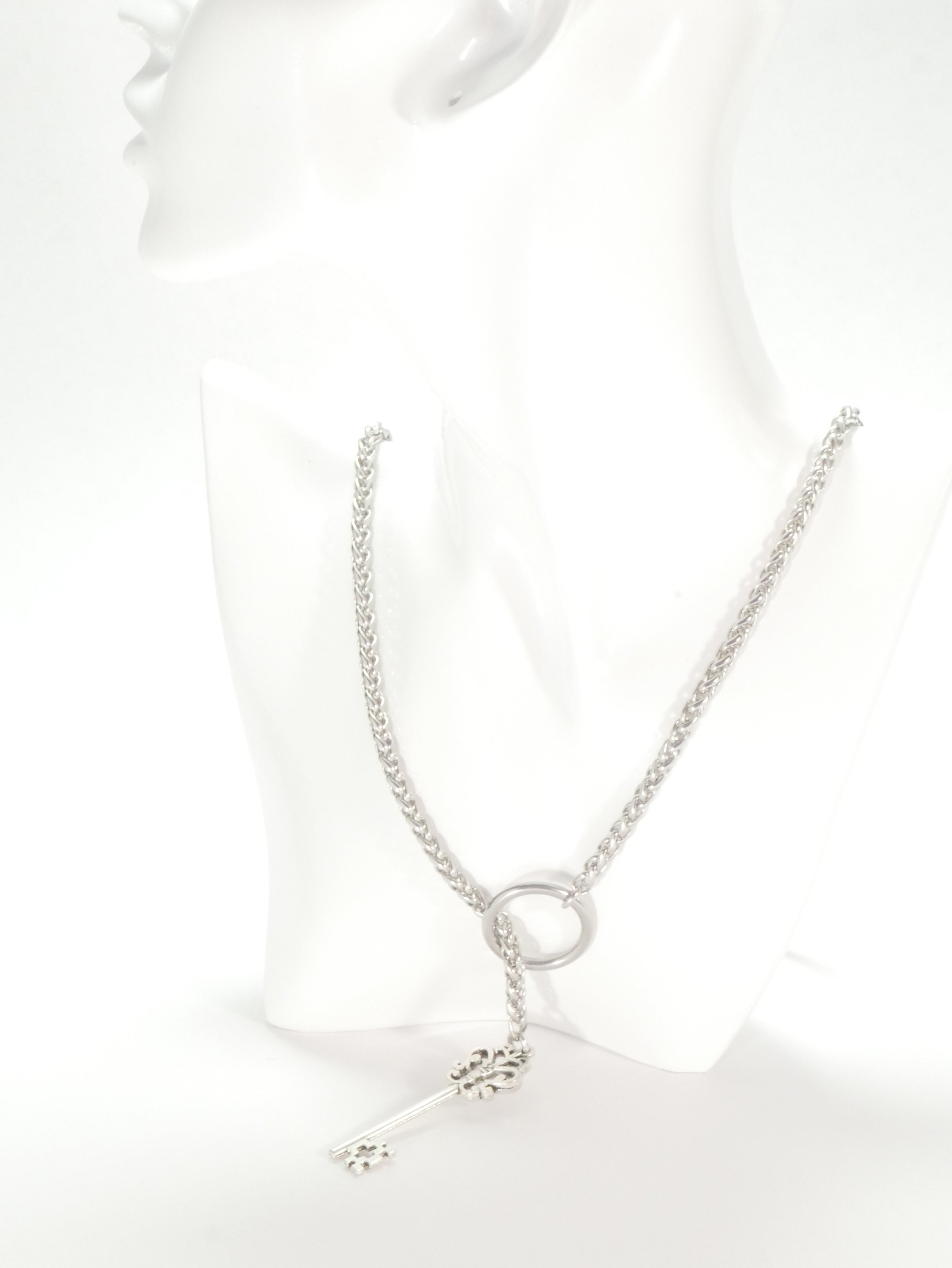 Silver necklace with a delicate pendant on a white background