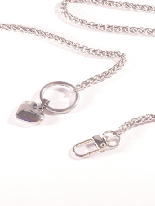 Silver necklace with a heart-shaped pendant on a white background