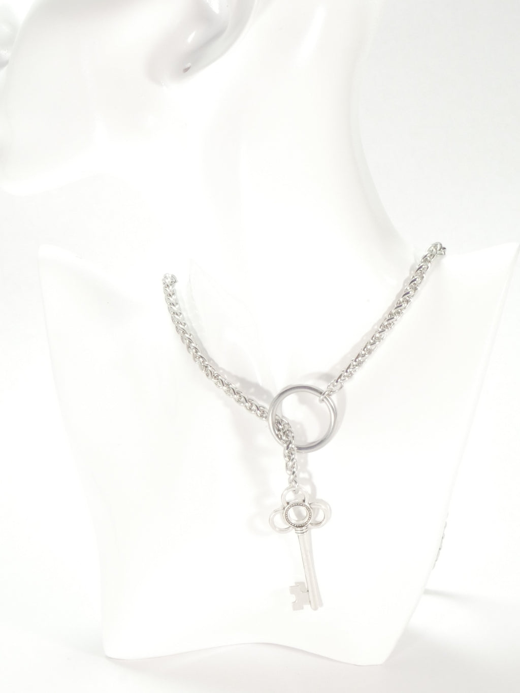 Silver key-shaped pendant on a chain against a white background