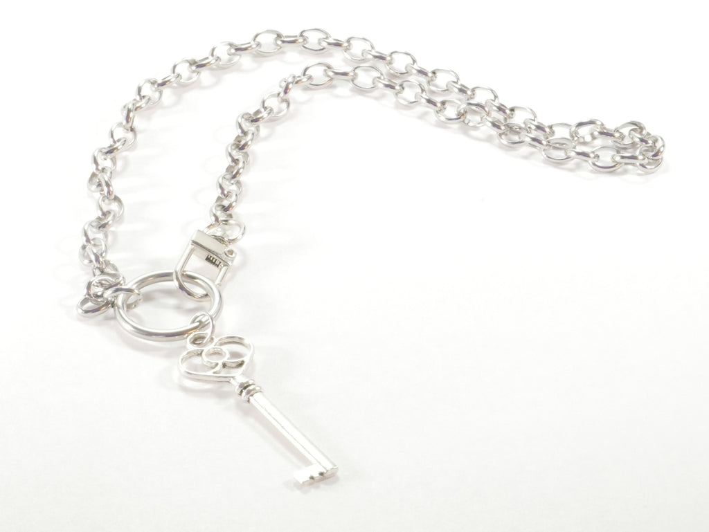 Silver key necklace on a white background