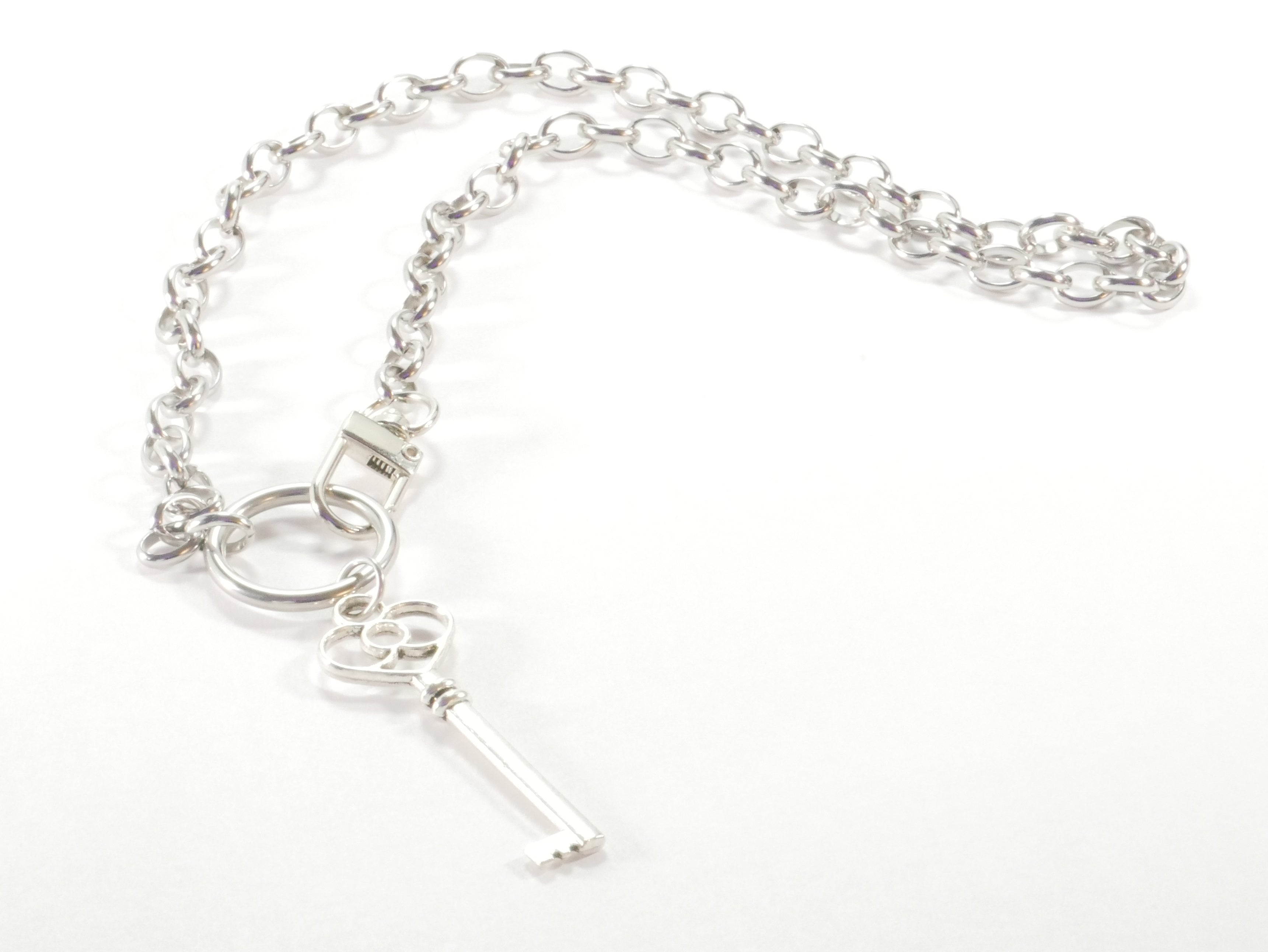 Silver key necklace on a white background