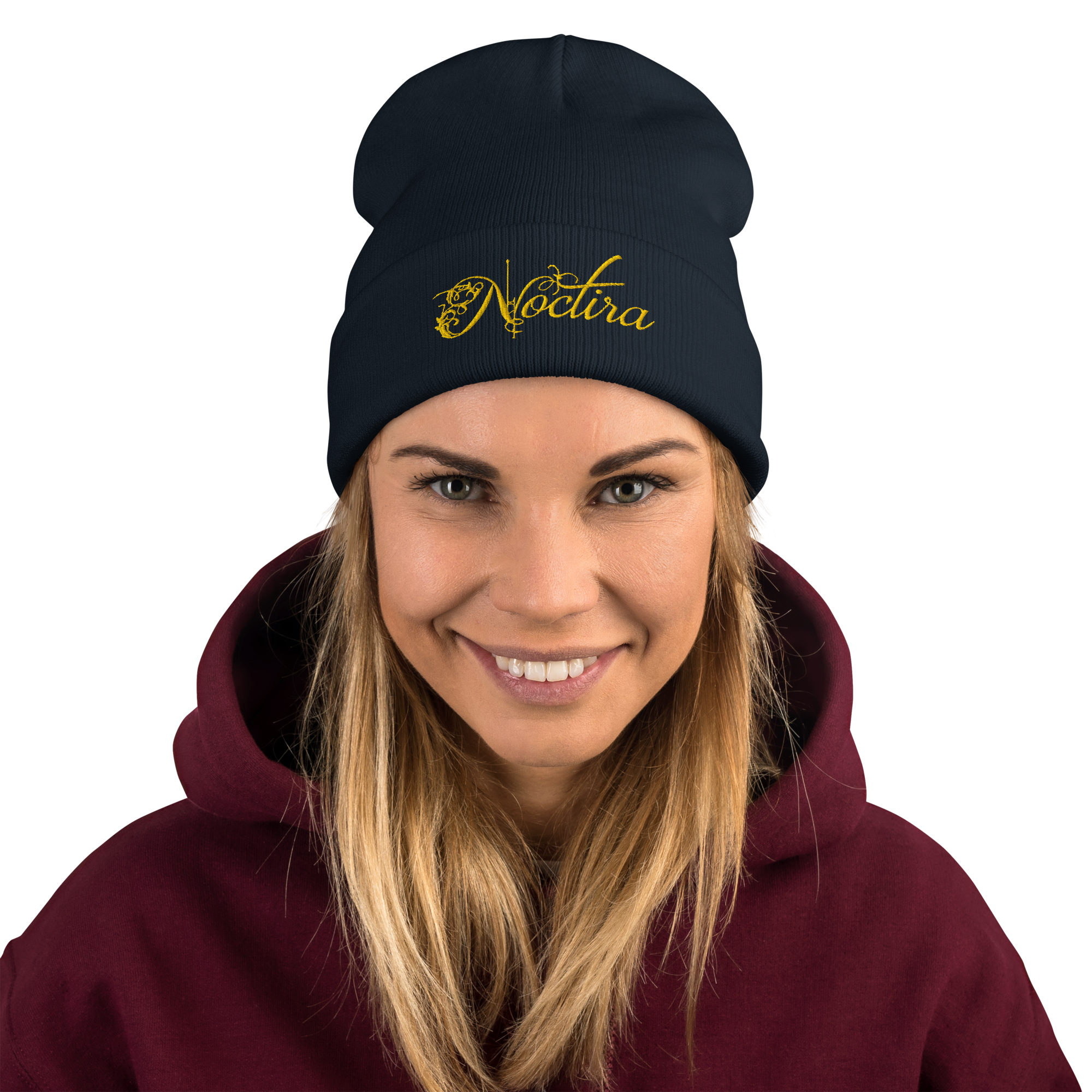 Person wearing a dark blue beanie with 'Noctura' logo and a maroon hoodie on a white background