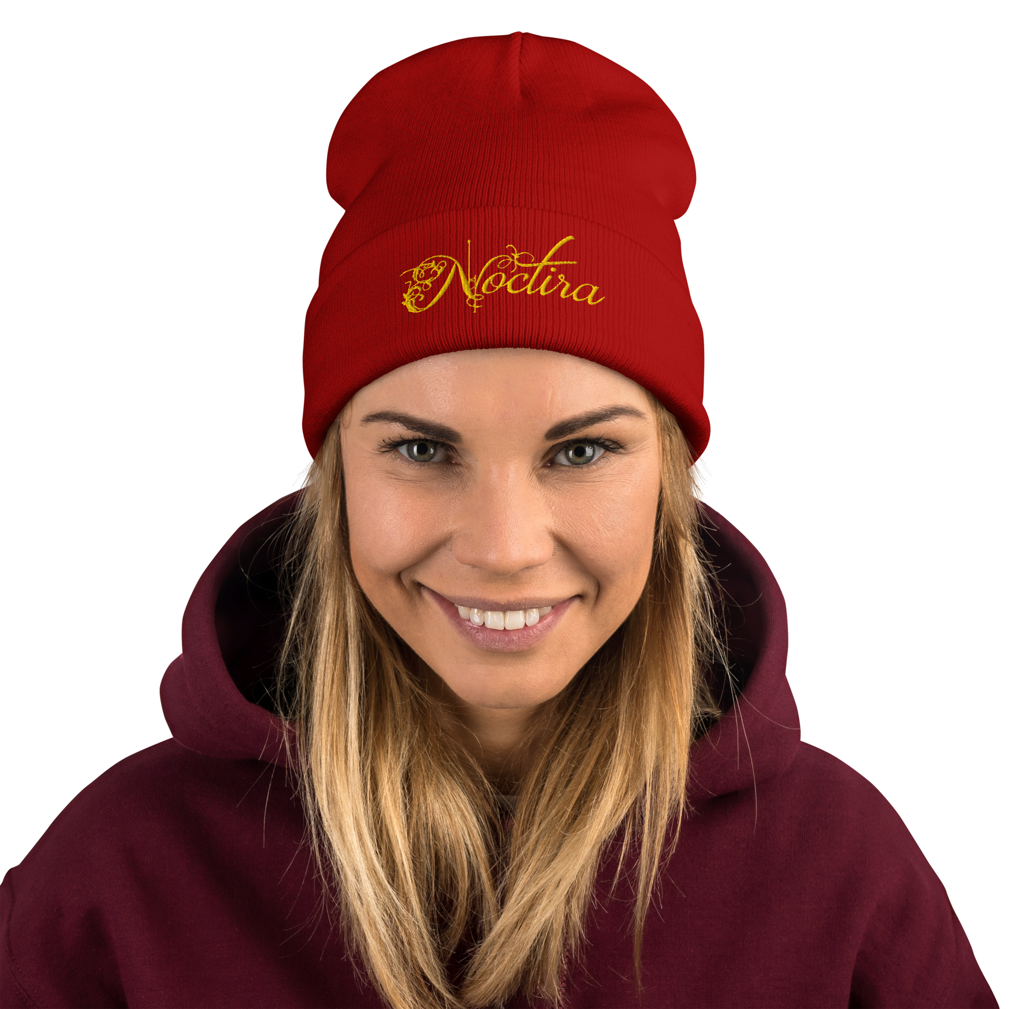 Person wearing a red beanie with 'Noctura' logo and a maroon hoodie on a white background
