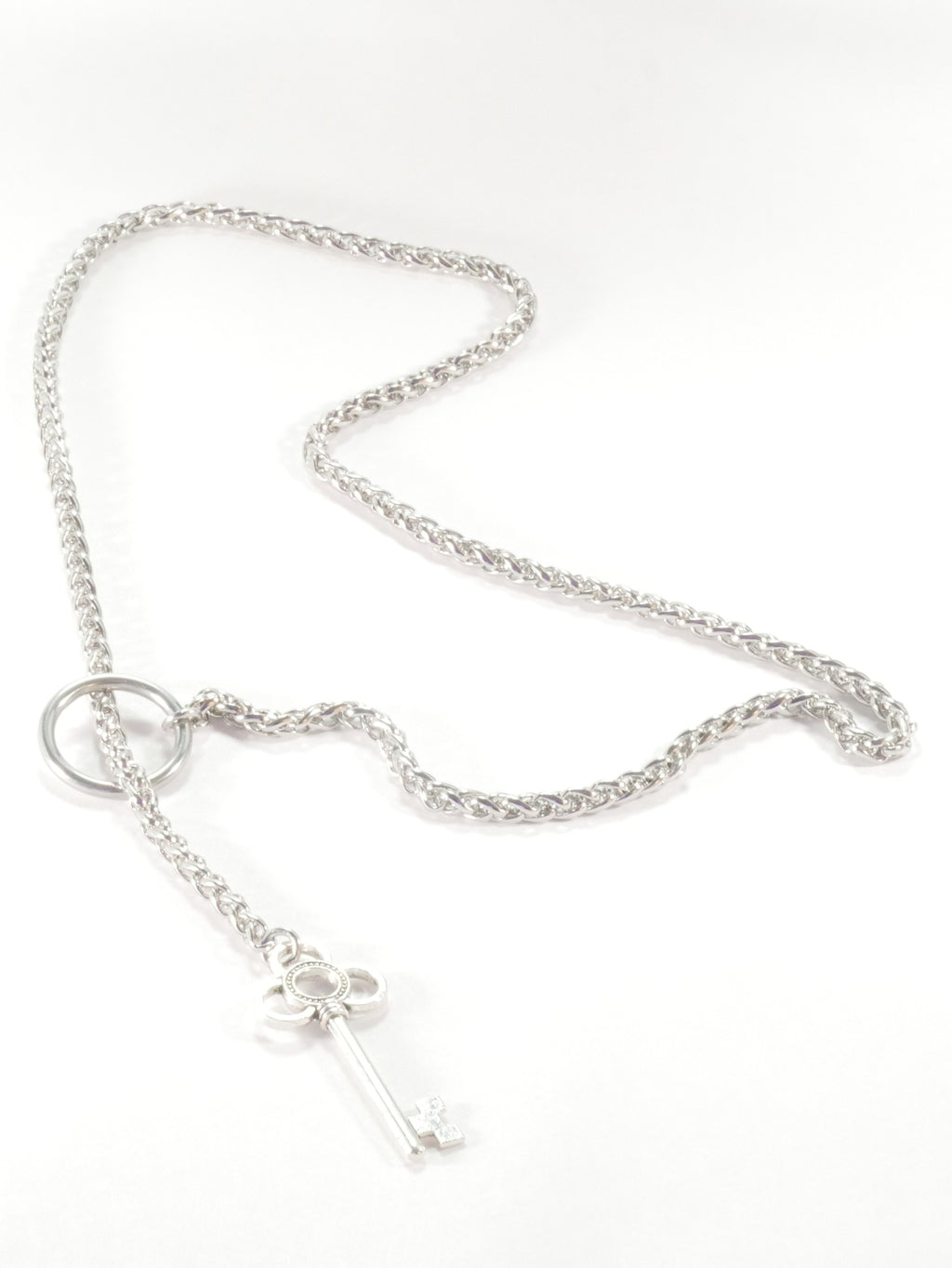 Silver necklace with a small pendant on a white background