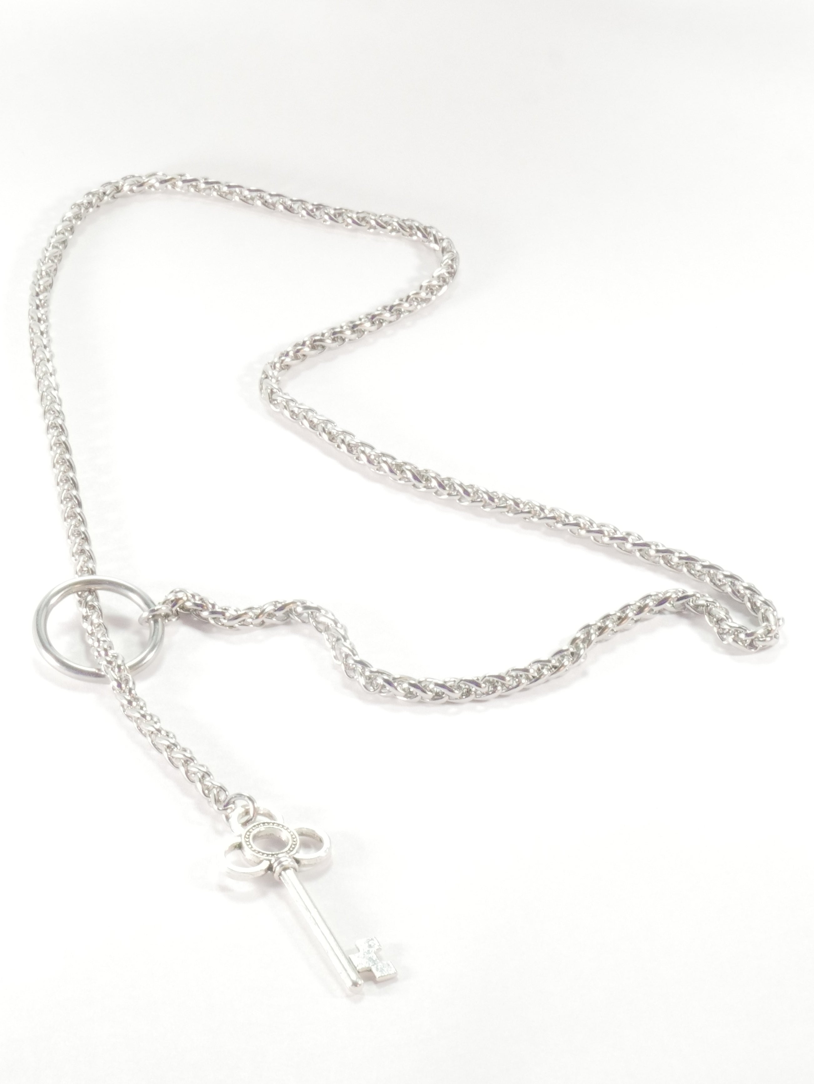 Silver necklace with a small pendant on a white background