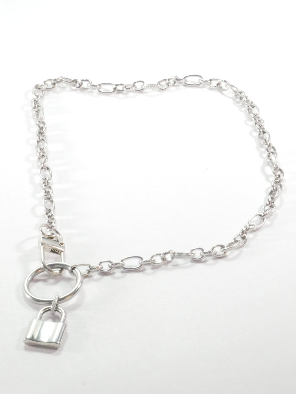 Silver chain bracelet with a lock charm on a white background