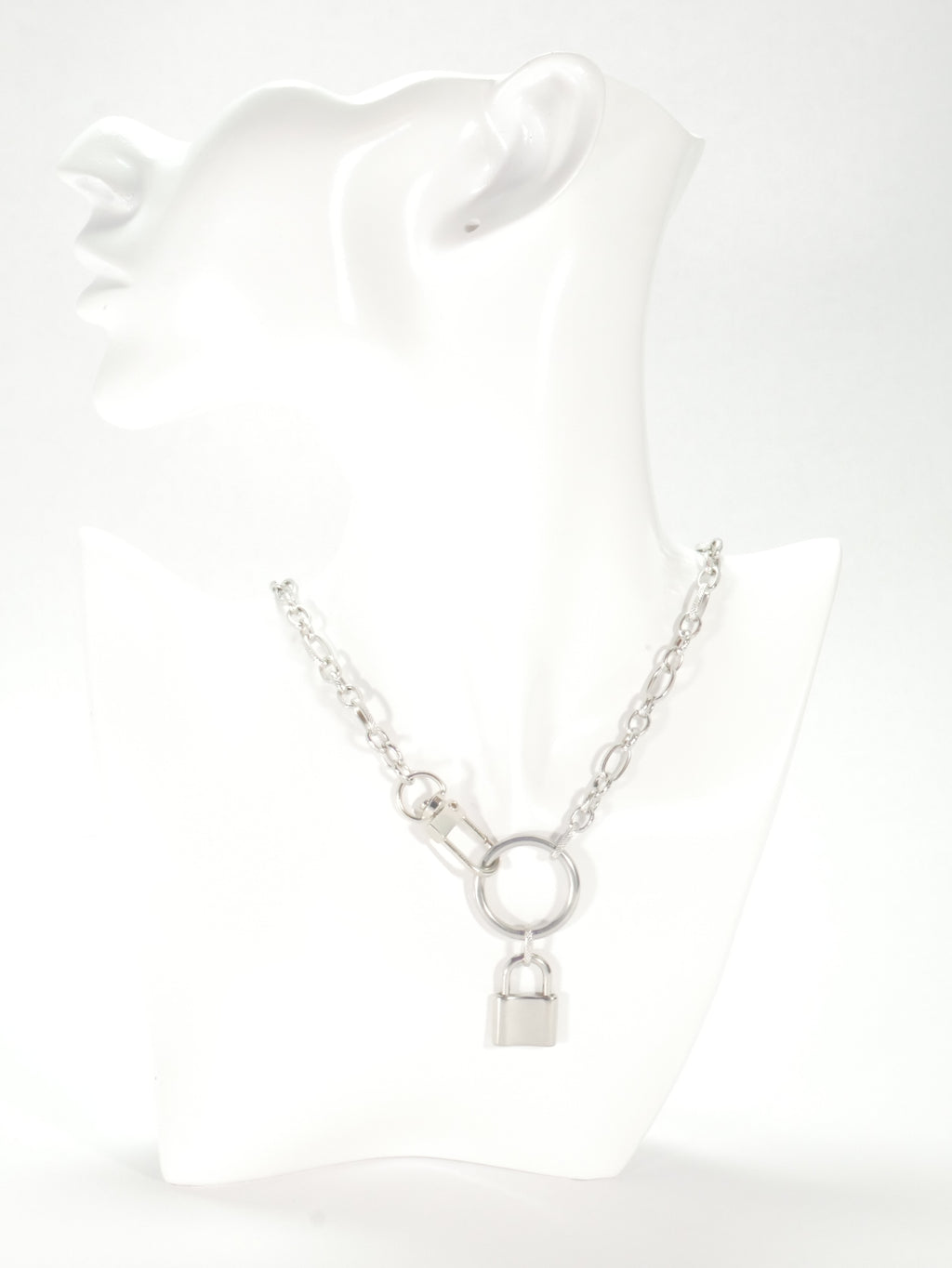 Silver bracelet on a white mannequin arm with a plain background