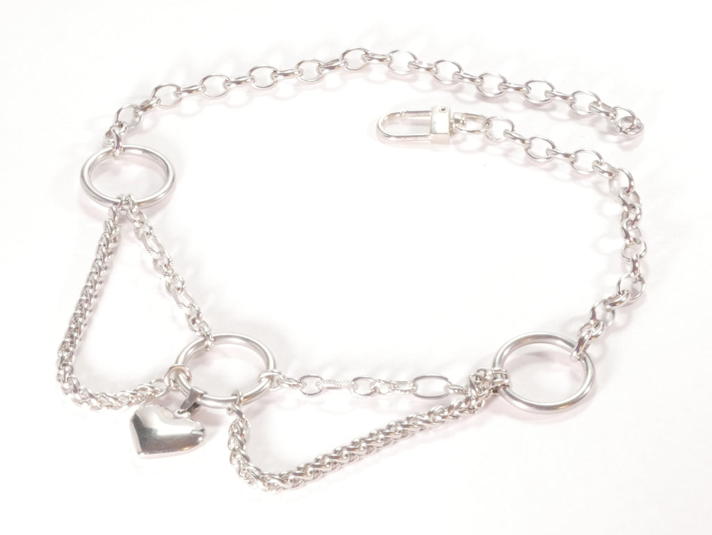 Silver collar with heart charm on a white background