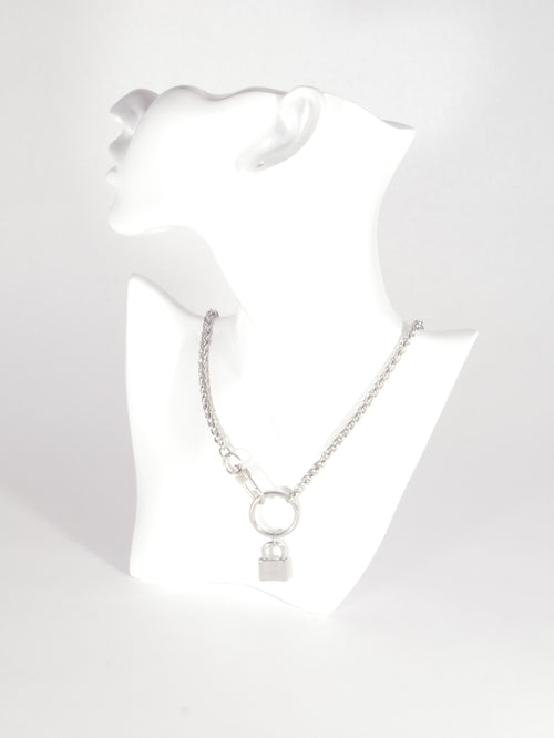 Silver bracelet on a mannequin arm against a white background