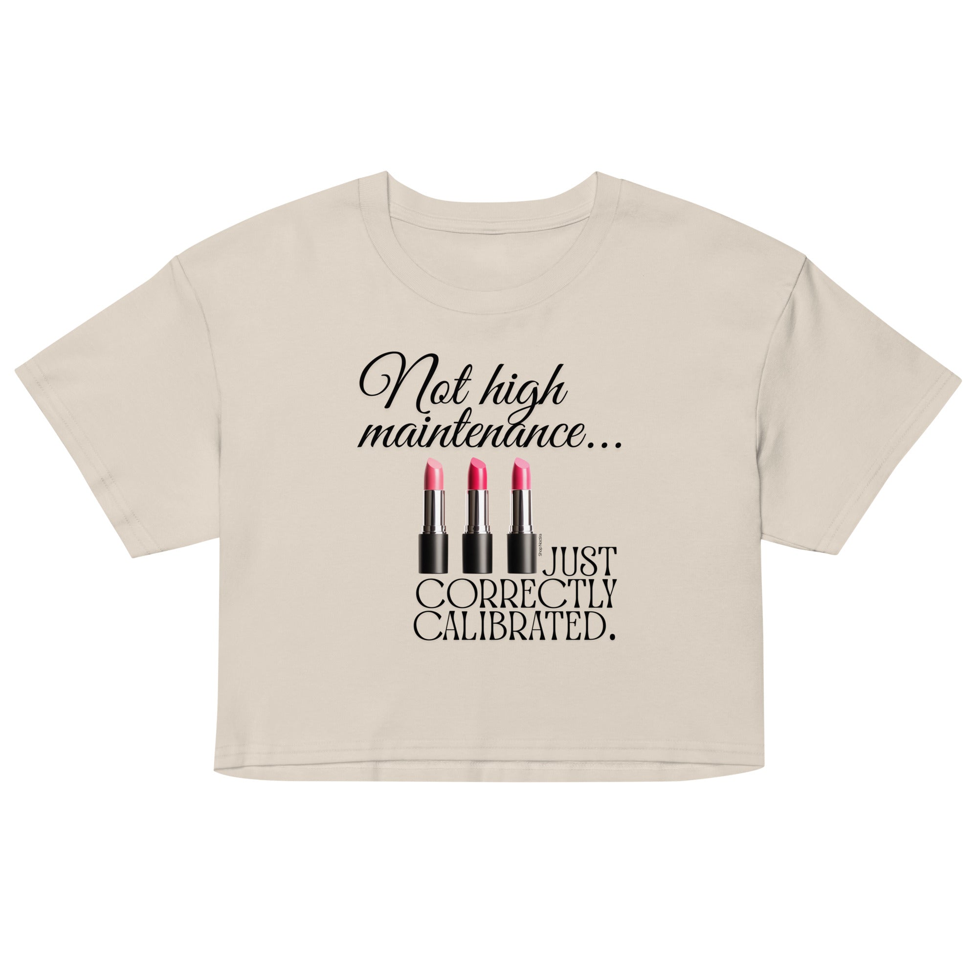 Beige crop top with black text and lipstick graphics on a white background