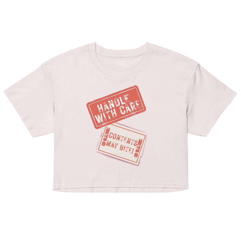 Pink crop top with 'Handle with Care' and 'Contents May Vary' text on a white background