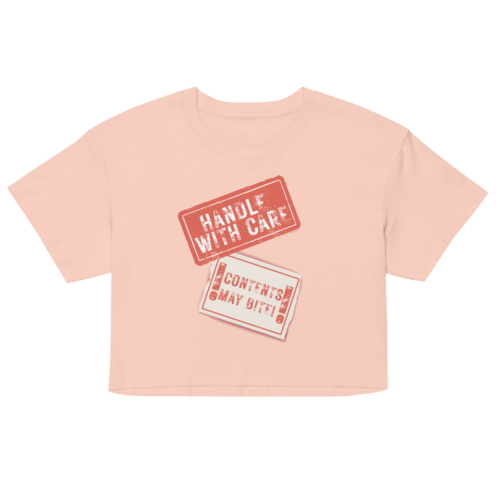 Pink crop top with 'Handle with Care' text on a white background